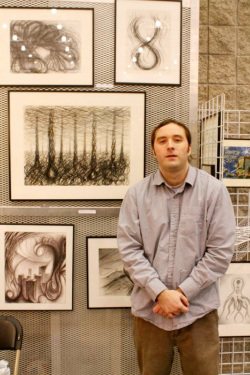 Picture of Mike W Morgan with some of his artwork (Hampton Roads Convention Center. 